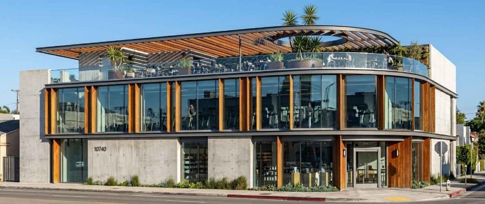 Street elevation of the 10740 Ventura Blvd retail building with rooftop pergola and planting