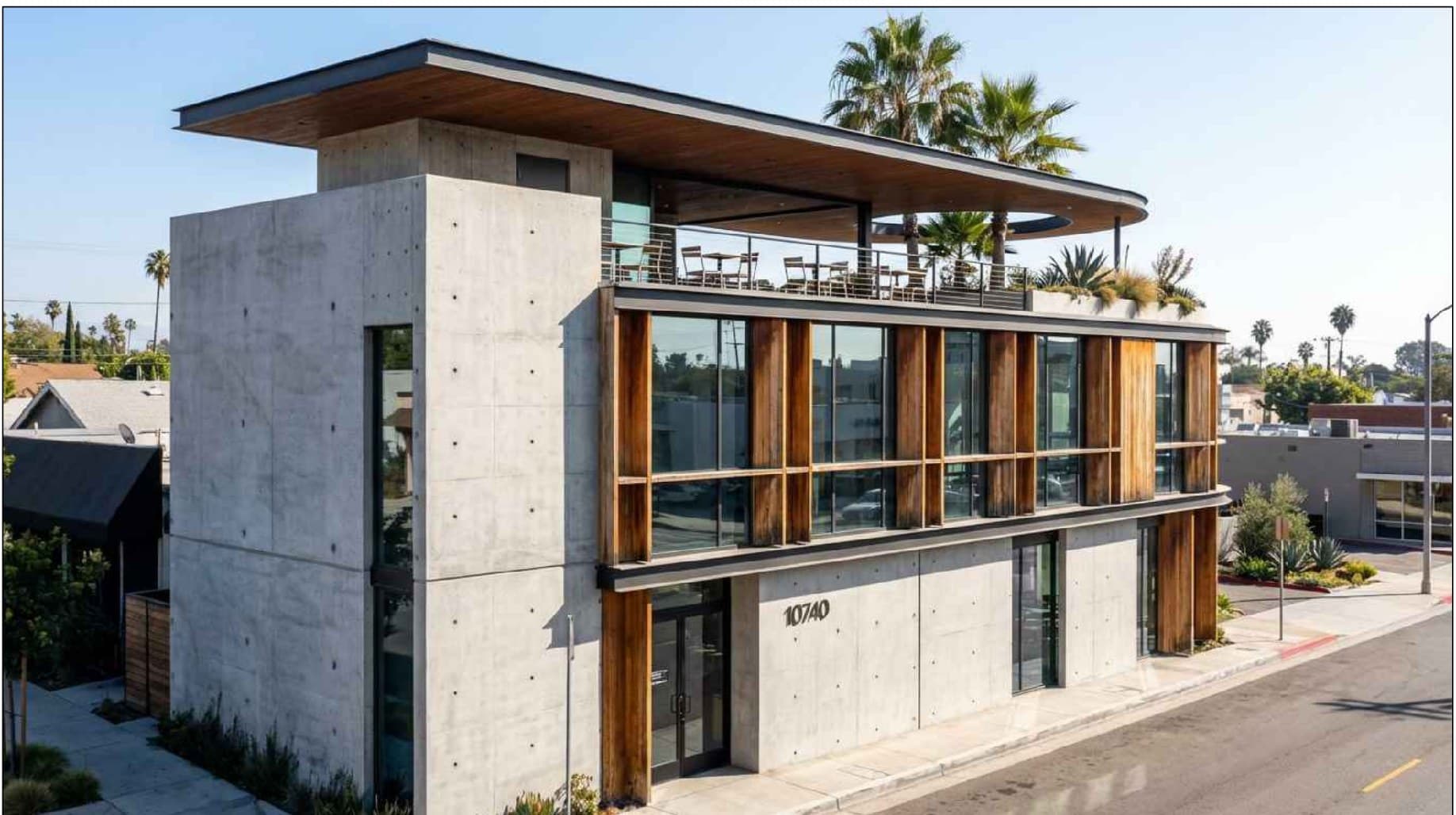 Two-story concrete and glass retail building at 10740 Ventura Blvd with rooftop terrace